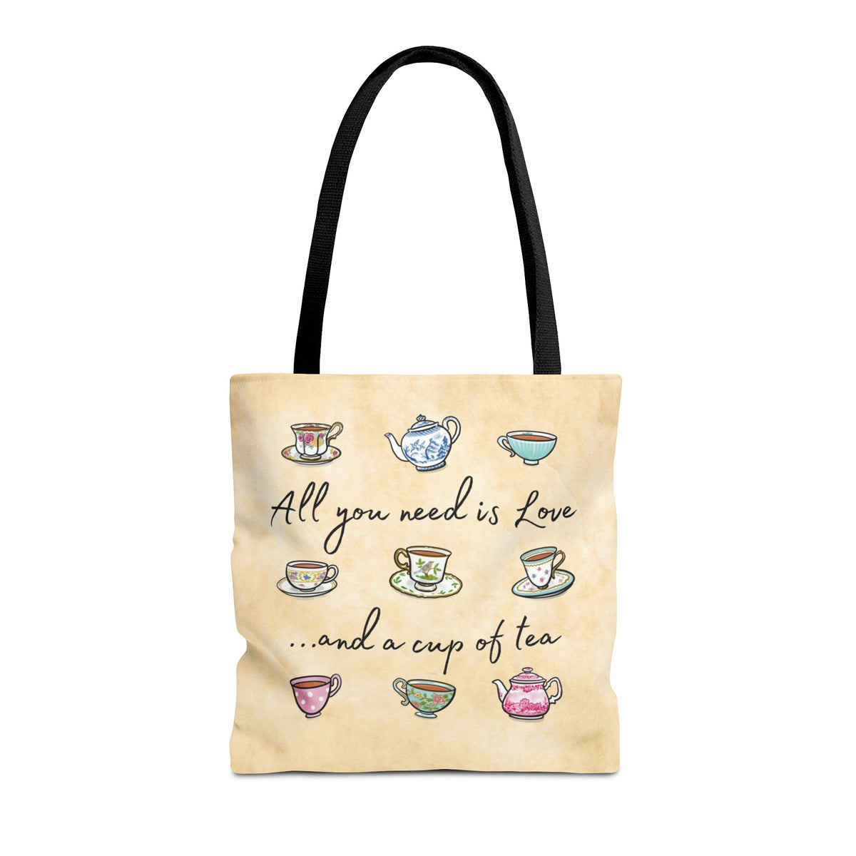 Beige tote bag with black handles, hand drawn teacups and teapots design. Lettering states "All you need is Love and a cup of tea"