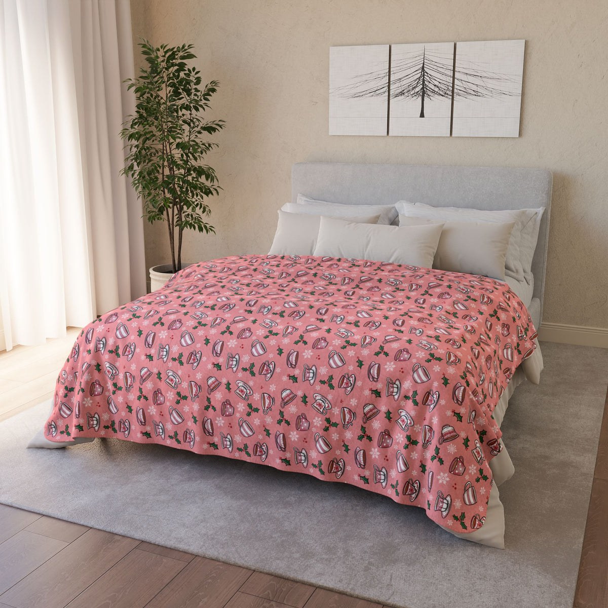 Bed with Pink blanket draped over it. Blanket design is hand drawn teacups with holly and snowflakes 