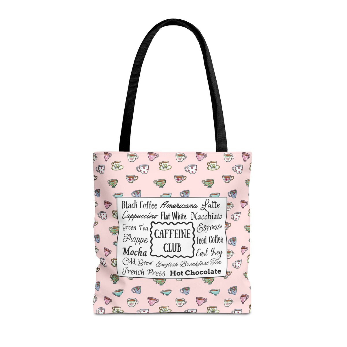 A light pink tote bag with black shoulder straps, featuring a pattern of small hand drawn cups and mugs and  a central white label listing various coffee and tea types.