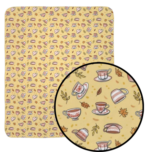 Hand drawn autumn teacups design on a pale yellow fleece blanket with detail call out