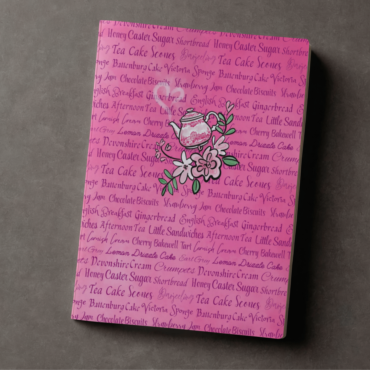 Pink journal with tea time treats word background design and whimsical hand drawn teapot accent
